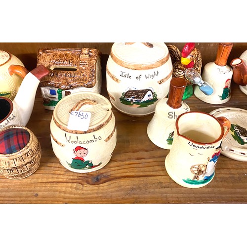 25 - Shelf of holiday souvenir pottery / china