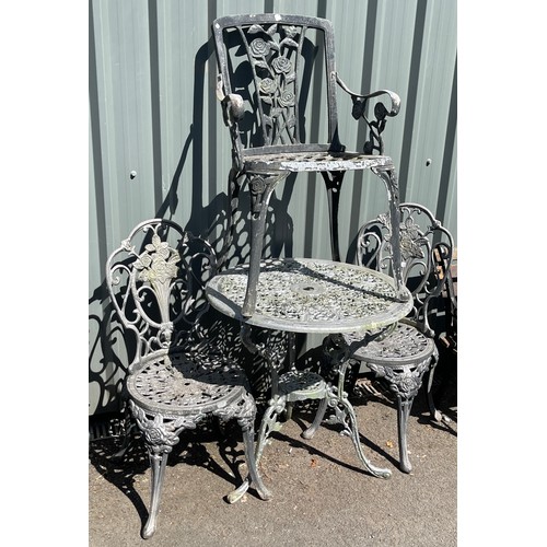 100E - Cast iron table and 3 chairs