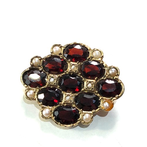 93 - 9ct gold garnet and seed-pearl brooch measures approx 2.8cm by 2.2cm weight 6.2g one pearl replaced