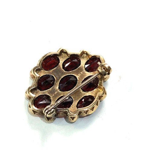 93 - 9ct gold garnet and seed-pearl brooch measures approx 2.8cm by 2.2cm weight 6.2g one pearl replaced