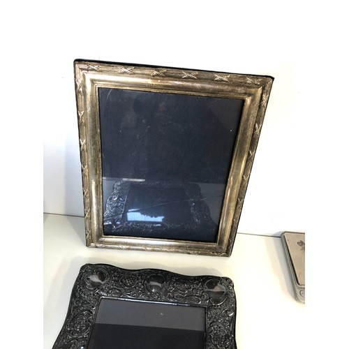 67 - 2 large silver picture frames measure approx 32cm by 24cm glass cracked and back stand come away on ... 