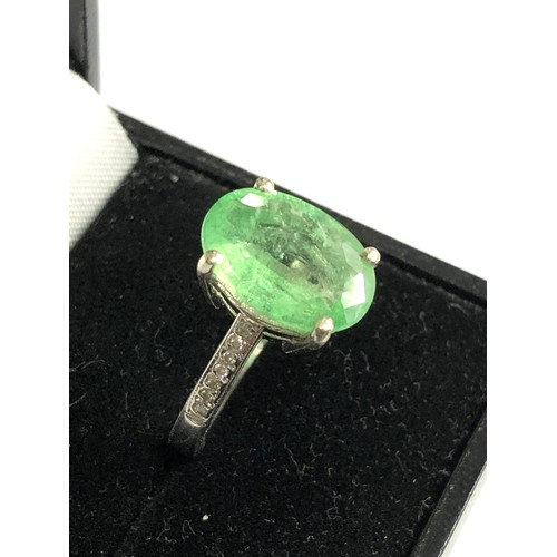76 - 9ct white gold diamond and emerald ring large central emerald measures approx 13mm by 10mm with diam... 