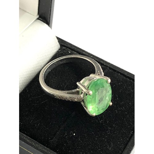 76 - 9ct white gold diamond and emerald ring large central emerald measures approx 13mm by 10mm with diam... 