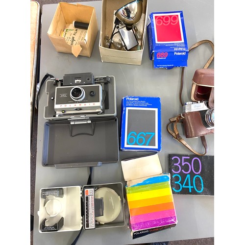 35 - Selection of cameras and cameras equipment to include polaroid 340 and a super halina vintage camera... 