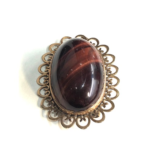 260 - Large 9ct gold tigers eye stone set pendant / brooch measures approx 4.2cm by 3cm weight 13.9g