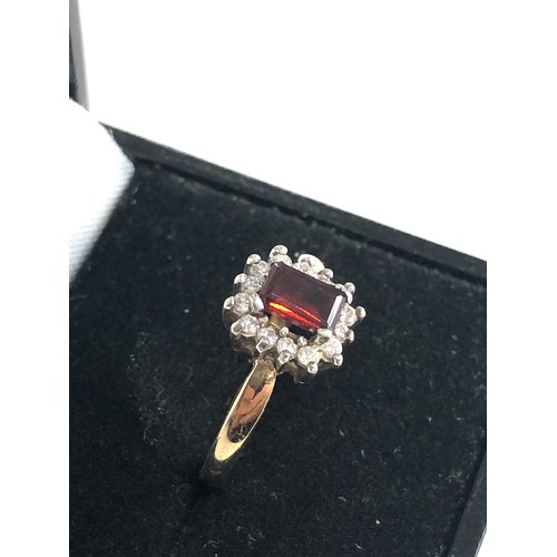 143 - 9ct gold garnet halo ring weight 3.1g