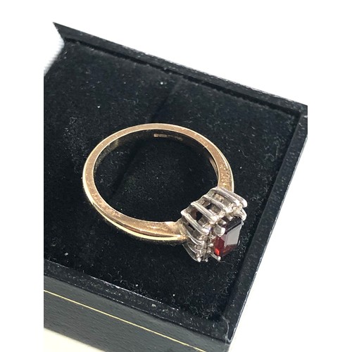 143 - 9ct gold garnet halo ring weight 3.1g