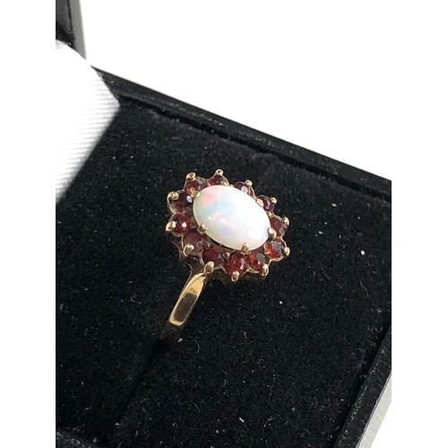 276 - 9ct gold opal & garnet halo ring weight 1.9g