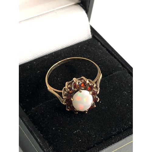 276 - 9ct gold opal & garnet halo ring weight 1.9g