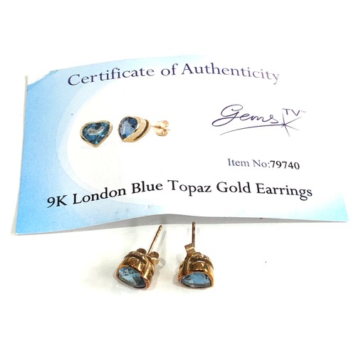 121 - Certificated 9ct gold blue topaz gold earrings