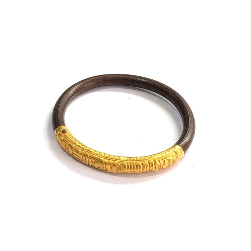 88 - Asian wood and 22ct gold bangle