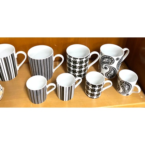 121 - Selection of black and white LSA mugs, small mugs and saucers, all in good overall condition