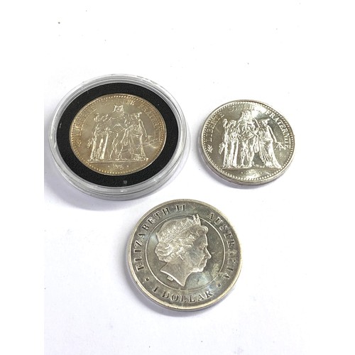 522 - 3  silver coins includes 2  10 francs and 1oz elizabeth 1 dollar