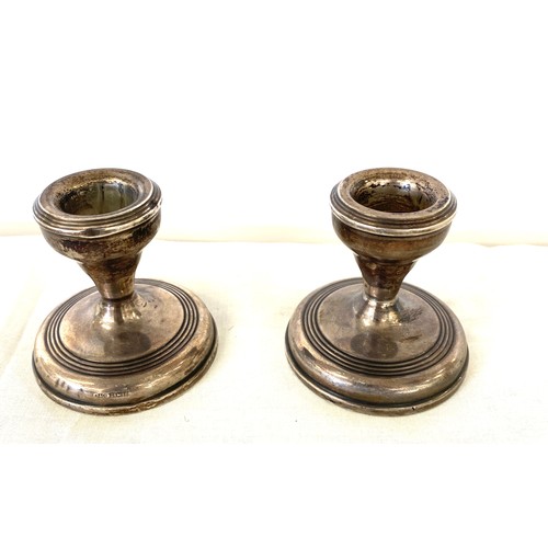 696 - 2 silver miniature filled candlesticks