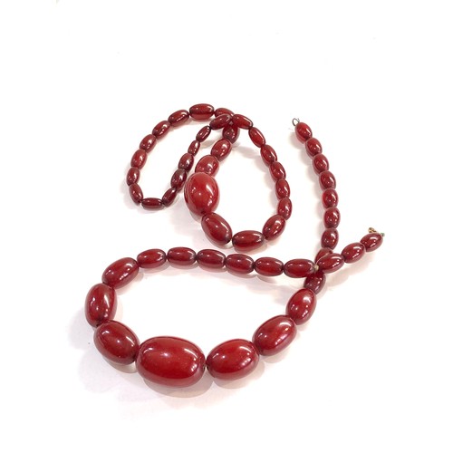 478 - 2 Cherry amber bakelite bead necklaces with internal streaking 58g