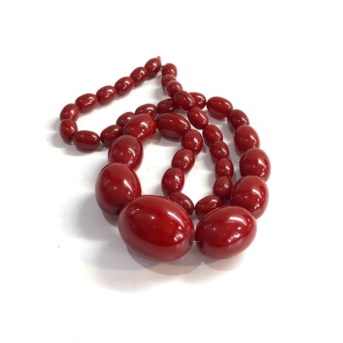 473 - Cherry amber bakelite bead necklace with internal streaking 84g