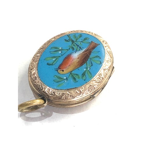 244 - Antique gold back and front enamel locket measures approx 3cm by 2.2cm