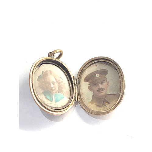 244 - Antique gold back and front enamel locket measures approx 3cm by 2.2cm