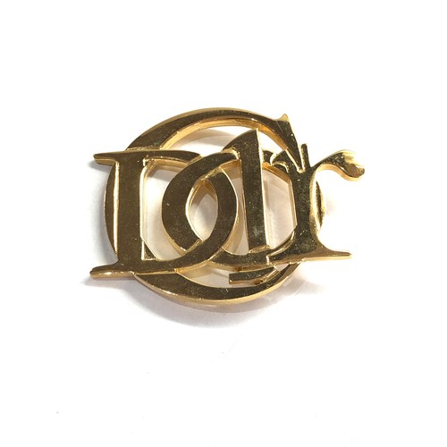 558 - Parfums Christian Dior brooch