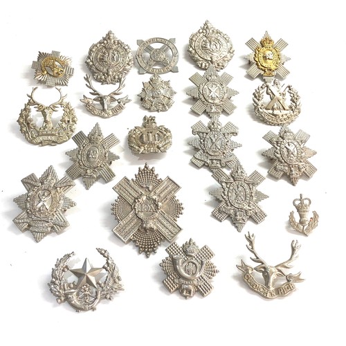 569 - Large selection of military cap badges