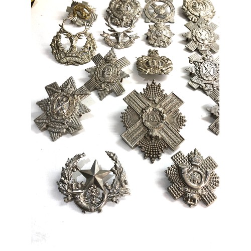 569 - Large selection of military cap badges