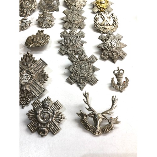 569 - Large selection of military cap badges