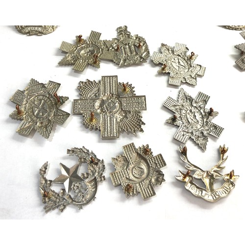 569 - Large selection of military cap badges