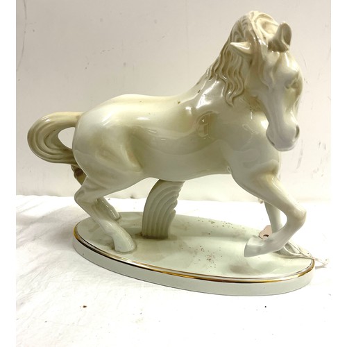 75 - Midehamiga white glazed ceramic horse figure measures approx 11 inches tall and 12 inches wide overa... 