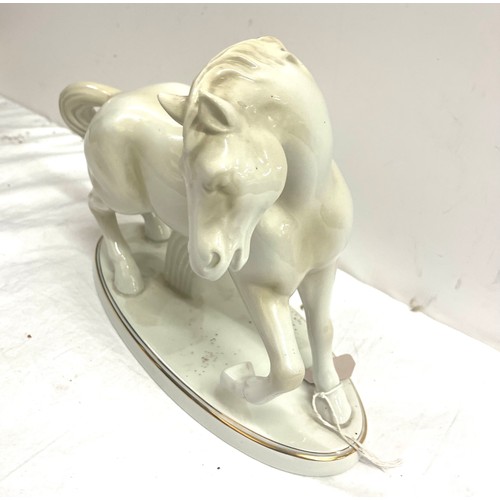 75 - Midehamiga white glazed ceramic horse figure measures approx 11 inches tall and 12 inches wide overa... 