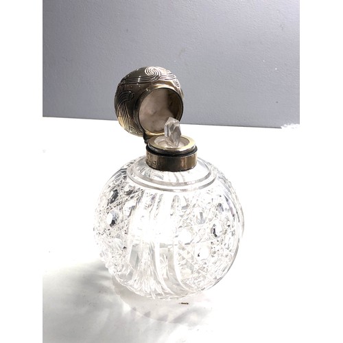 10 - Antique  large silver top & cut glass scent bottle measures approx 15.cm tall 11cm dia complete with... 