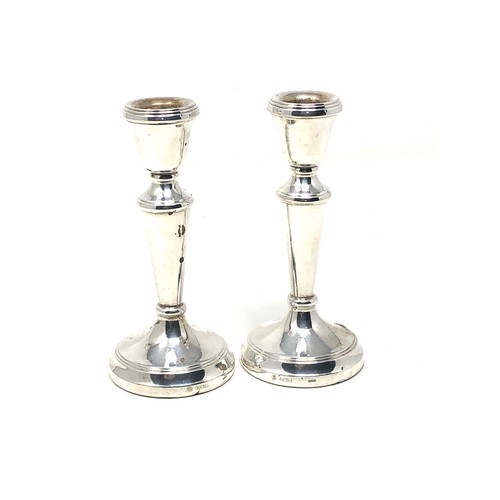 84 - Pair of silver candlesticks Birmingham silver hallmarks measure height 14.5cm filled bases