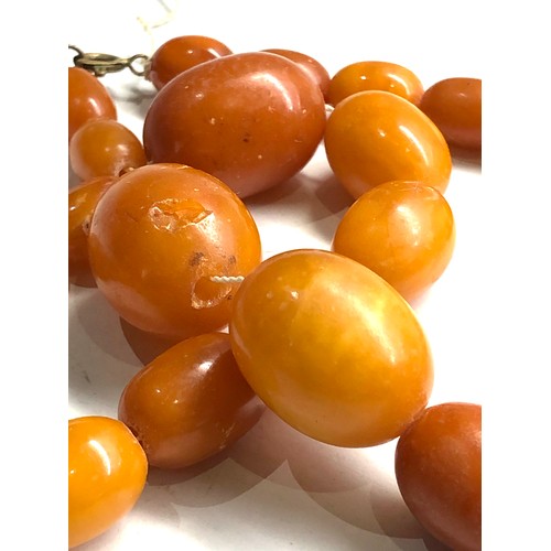 334 - Egg yolk amber bead necklace & earrings chips to amber total weight 47g