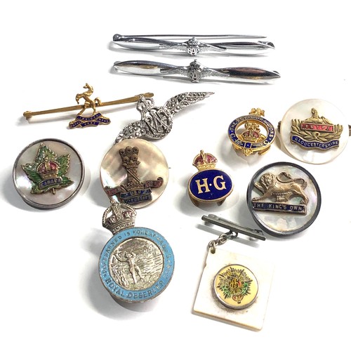 385 - 12 military badges includes sweetheart etc