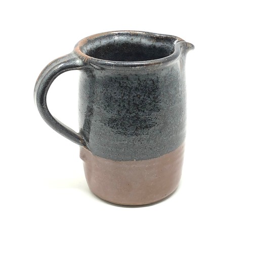 435 - Muchelney studio pottery jug measures approx 13.5cm tall 9.5cm dia