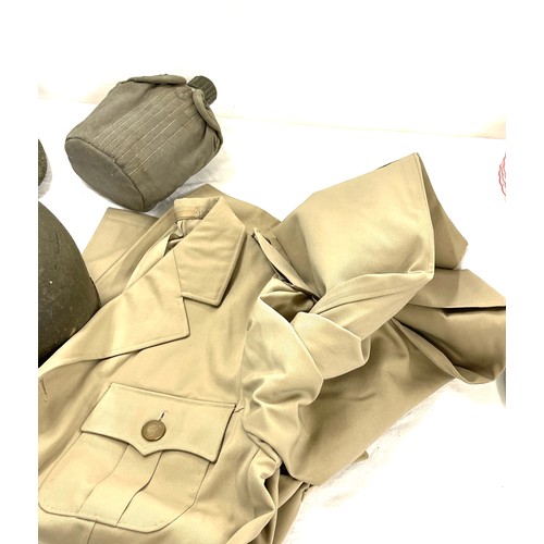 280 - Selection of military uniform to include 2 jackets, 1 cap, 1 hard hat, drinking bottle