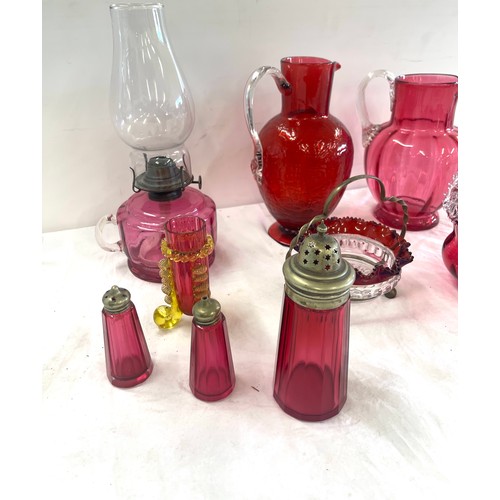 273 - Selection of antique and later Cranberry glass to include an oil lamp, jugs etc