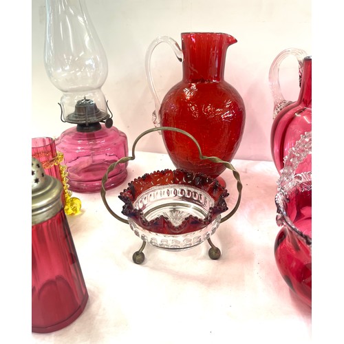 273 - Selection of antique and later Cranberry glass to include an oil lamp, jugs etc