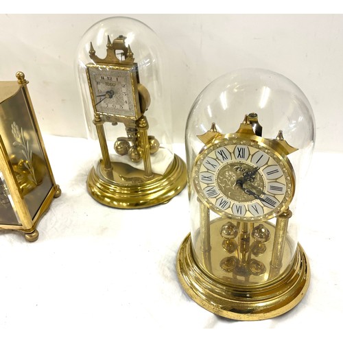 177 - 3 Vintage dome clocks with glass domes and 1 other carriage clock