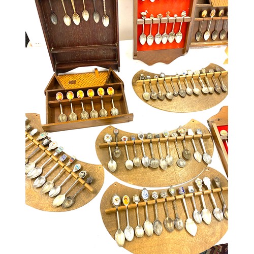 222 - Large selection of souvenir spoons and display racks