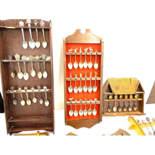 222 - Large selection of souvenir spoons and display racks