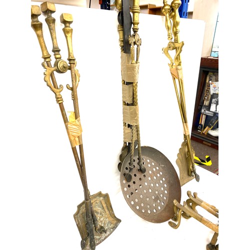 104B - Large selection of brass companion sets and fire dogs