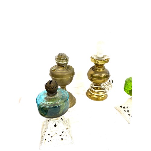 134 - 4 Vintage oil lamps, one has been converted into electric