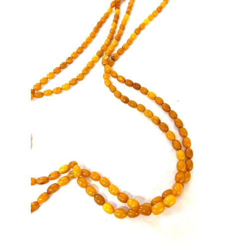 556 - Vintage long amber bead necklace, approximate weight of necklace 89g, approximate length 250cm