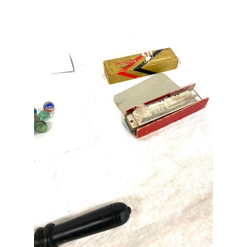 86 - Selection of miscellaneous pieces to include marbles, harmonicas etc