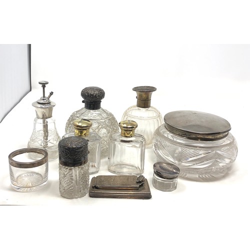 57 - Selection of silver items includes scent bottles silver top jars etc