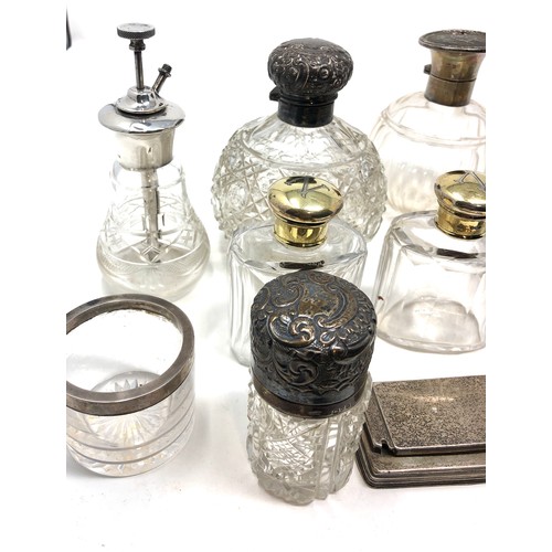 57 - Selection of silver items includes scent bottles silver top jars etc