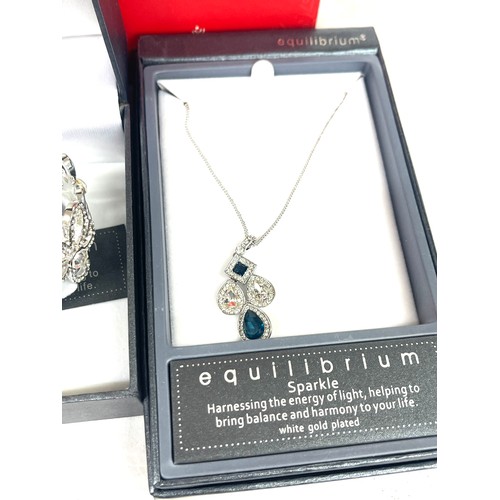 562 - Selection ladies boxed Equilibrium white gold plated necklaces, bangles etc