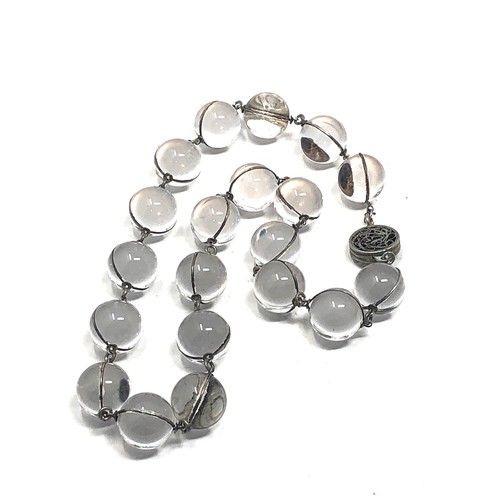 90 - An antique polished rock crystal orb pool of light necklace, silver fittings  With a matching pair o... 