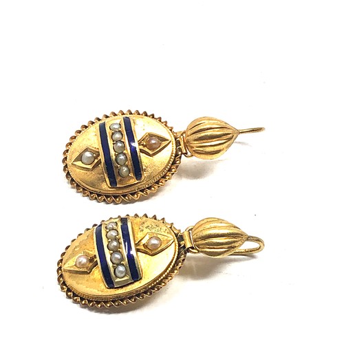 99 - A pair of antique English, 15 carat gold earrings; with applied designs decorated with blue enamel &... 