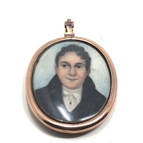 198 - An antique 9 carat gold framed locket pendant;  with a rounded glass holding a finely hand painted s... 